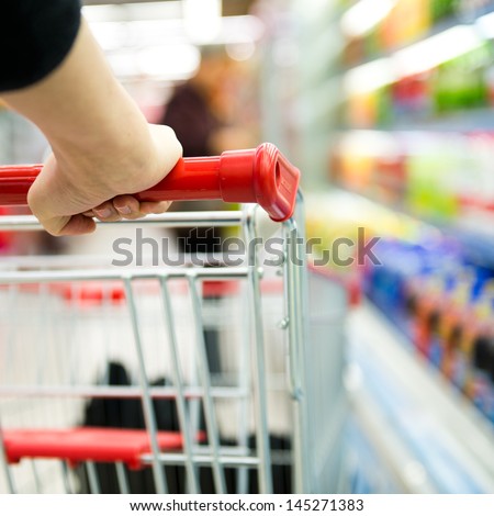 Closeup of woman with shopping cart.