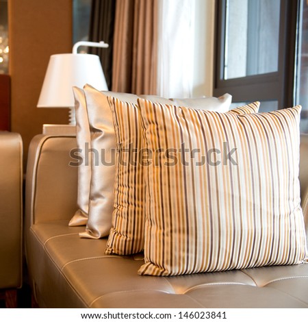 Comfortable corner in family room, with many pillows.