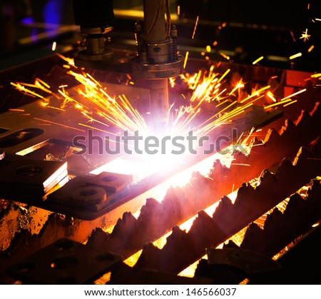 Industrial laser cutter with sparks Industrial laser cutter with sparks