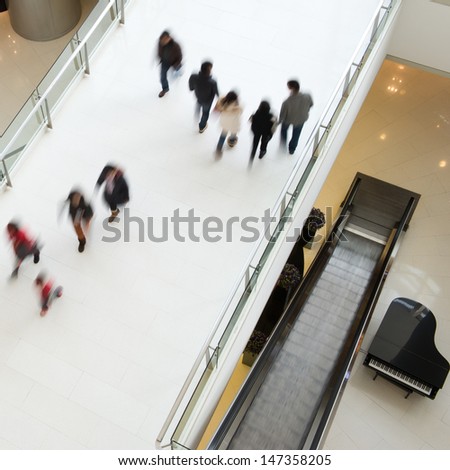 People in motion at the modern shopping mall.
