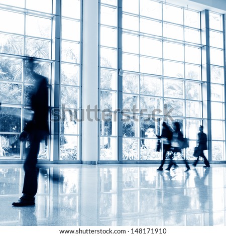Business People Rushing In The Lobby. Motion Blur