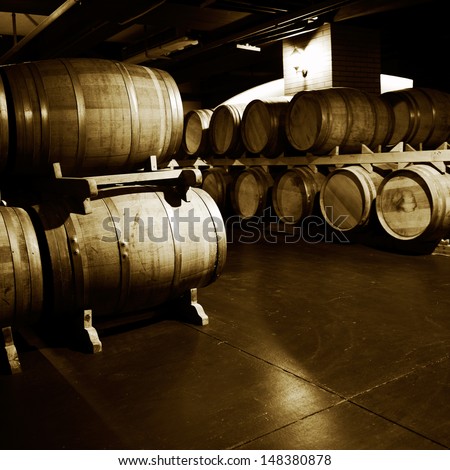 Wine Cellar With Many Wine Barrels.