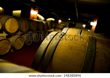 Wine cellar with many wine barrels.