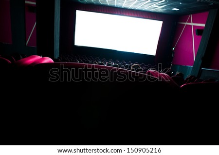 Dark movie theatre interior. tilted screen, chairs