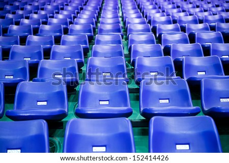 Rows of blue stadium seats with numbers.