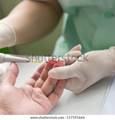 Doctor testing a patients blood.
