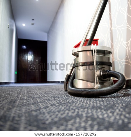 vacuum cleaner stands in the hotel corridor.