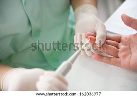 Doctor testing a patients blood.
