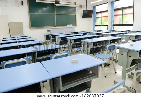 Empty classroom with chairs, desks.