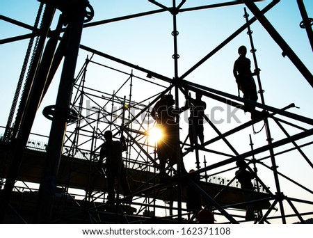 Construction workers working on scaffolding