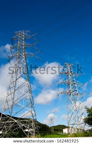 Electric power station against bright sky.