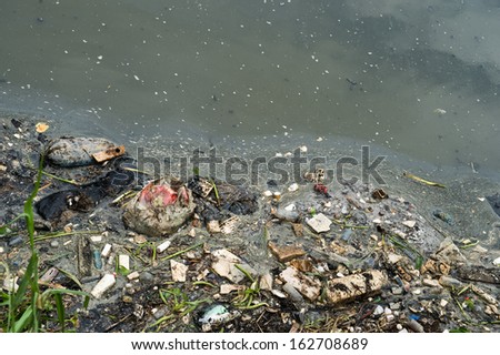 Water pollution in river with trash.