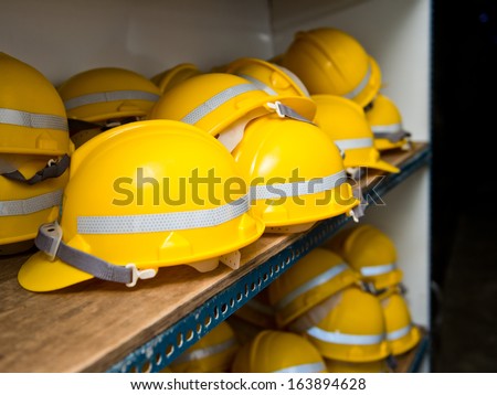 Some yellow construction helmets on work place.