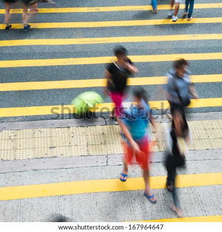 Busy city people on zebra crossing street in Hong Kong, China.
