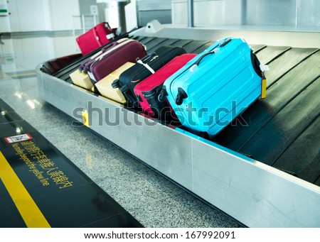 Suitcases On Conveyor Belt Of Airport.