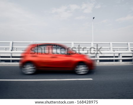 Blurred car speeding on the highway