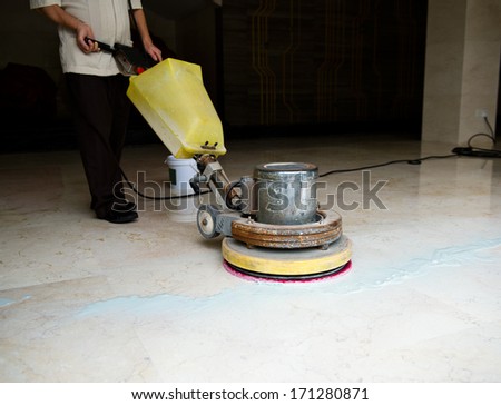 People cleaning floor with machine People cleaning floor with machine