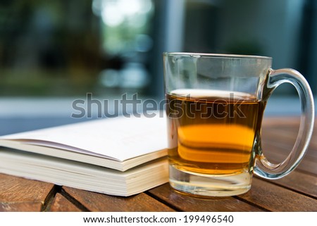 Book and tea on a wooden table