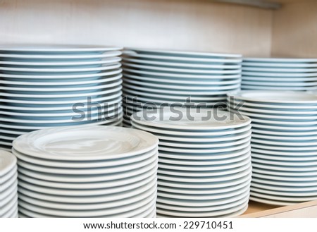 Group of white plates stacked together in a hotel.