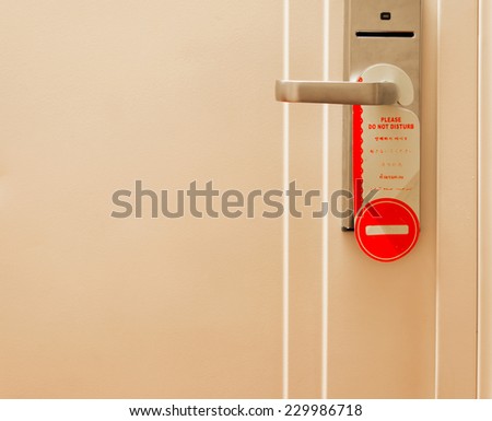 Do not disturb sign hang on hotel door knob.