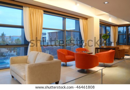 Modern interior of a room, with table sofa and window curtains