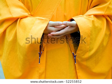 Chinese buddhist monk hand and fingers detail, the monk in praying.