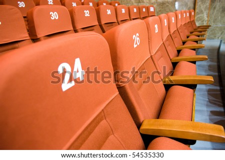 A line of red theater chairs.