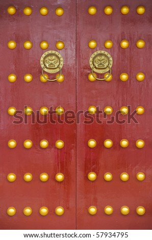 Red chinese door with a lion/dragon head. Concept: Chinese New Year celebration.