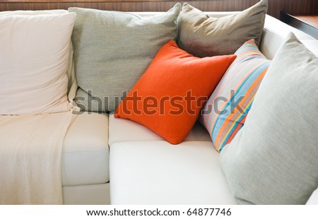 Comfortable corner in family room, with multi-colored pillows.