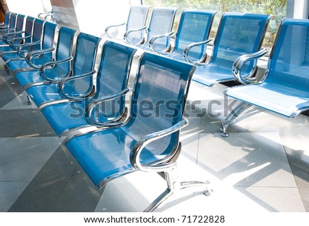 Hospital waiting room with empty chairs.