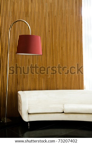 Modern and clean decoration of an apartment with a sofa and a lamp