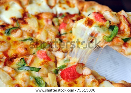 A slice of pizza with melting cheese