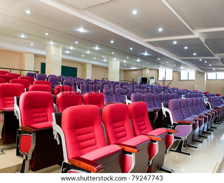 Empty hall for presentation with red and purple armchairs
