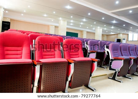 Empty hall for presentation with red and purple armchairs