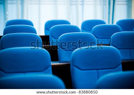 lines of blue theater chairs.