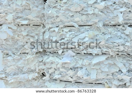stack of shredded paper at recycling plant.