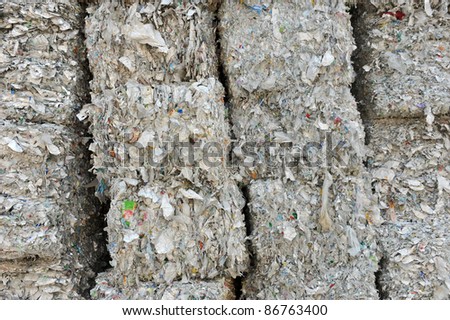 stack of shredded paper at recycling plant.