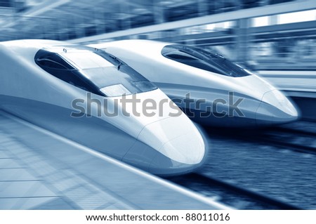 two modern train speeding with motion blur.