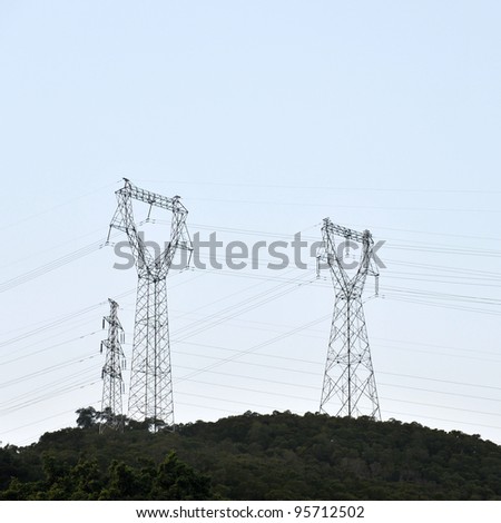 Electric power station against bright sky.