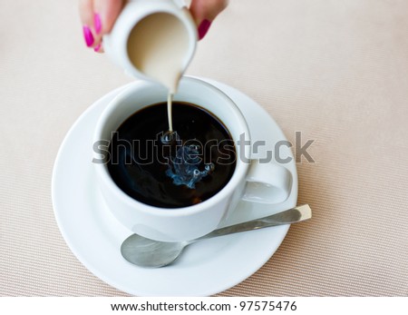 Woman stirring a cup of coffee