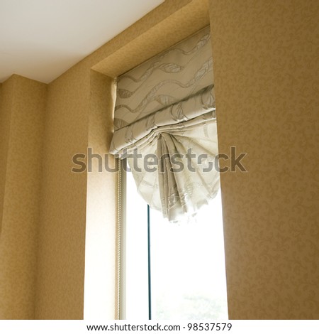 grey curtain in a room, with windows open