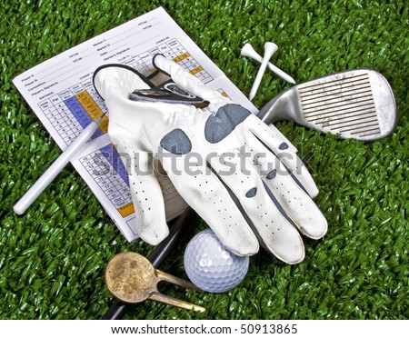 Collection of golf equipment resting on green grass