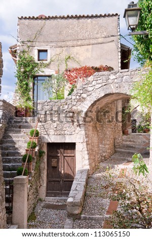 Romantic italian stone village, old stairway, door and arc.