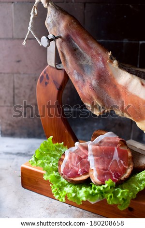 Rustic snack Prosciutto over a toasted piece of wheat bread and salad