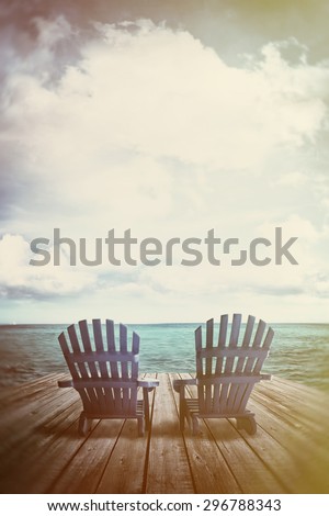 Blue adirondack chairs on dock with vintage textures and feel
