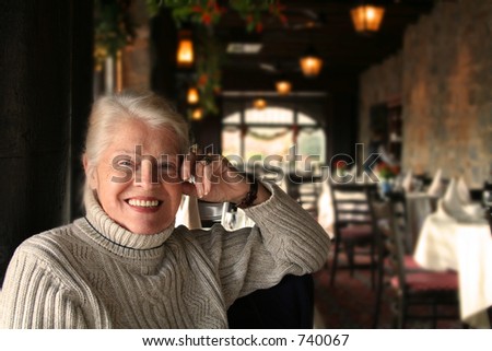 Elderly woman enjoying dinner at a restaurant