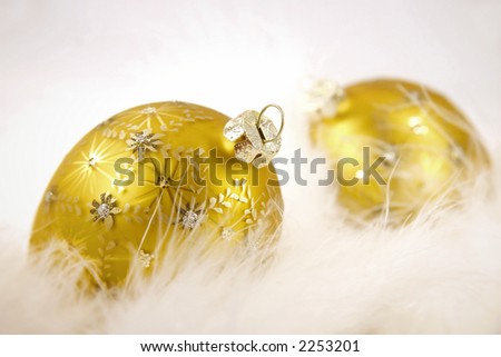 Gold christmas balls  in feathers on isolated white  background