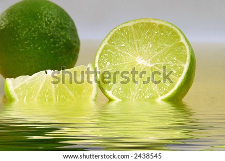 Freshly cut limes  with lime wedge in water