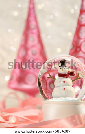 Snow globe with pink christmas trees in a winter white background