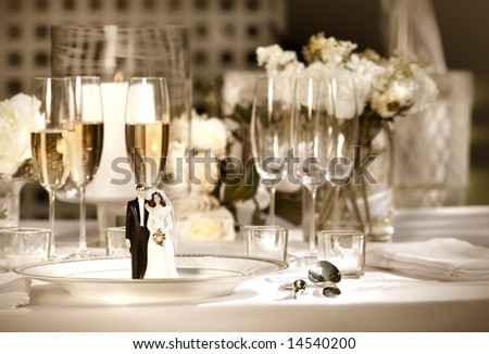 Cake figurines on dinner plate  at wedding reception/Sepia tone